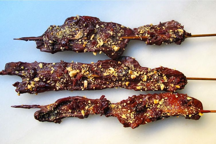 CHOCOLATE COVERED BACON ON A STICK WITH MARCONA ALMONDS AND DRIED CHERRIES
